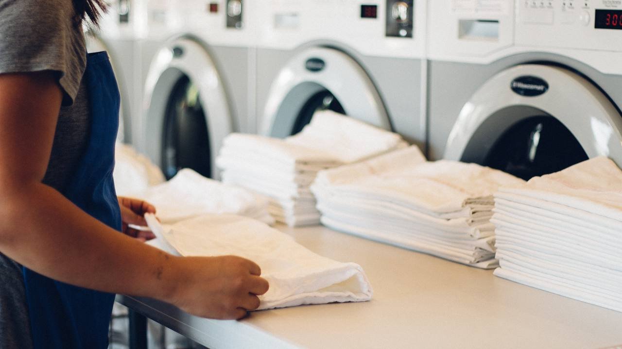 Staff folding clean laundry at Sparkling Wash